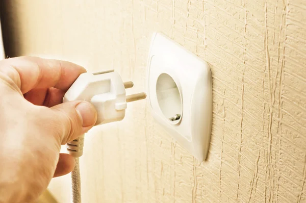 The process of connecting the white plug into the socket — Stock Photo, Image