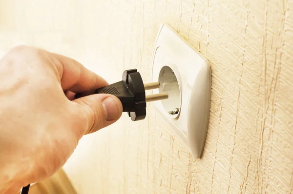 The process of connecting the black plug into the socket — Stock Photo, Image