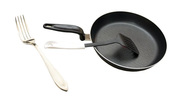 Chrome fork and frying pan with a spatula — Stock Photo, Image