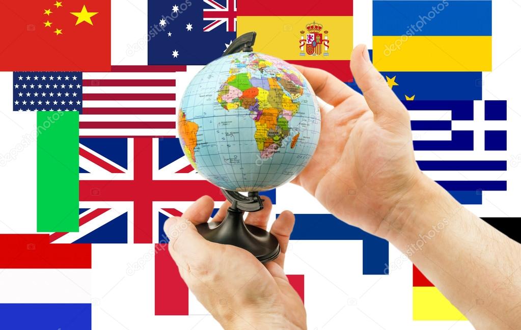 Globe in hands on a background of flags from around the world