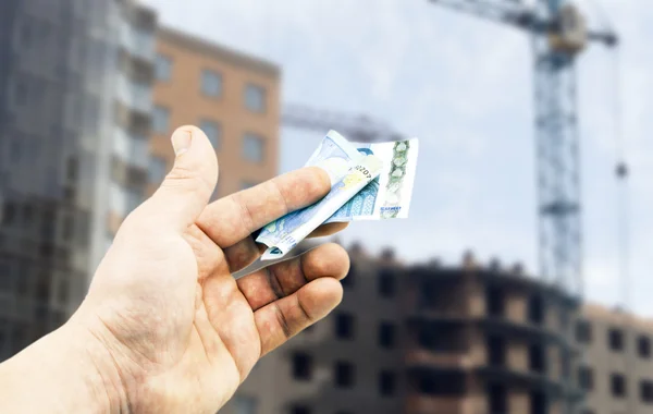 Euro in hand on a background of building Stock Image