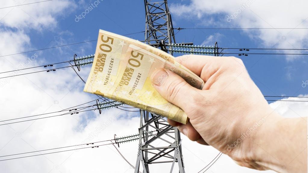 The euro in hand on the background of power lines