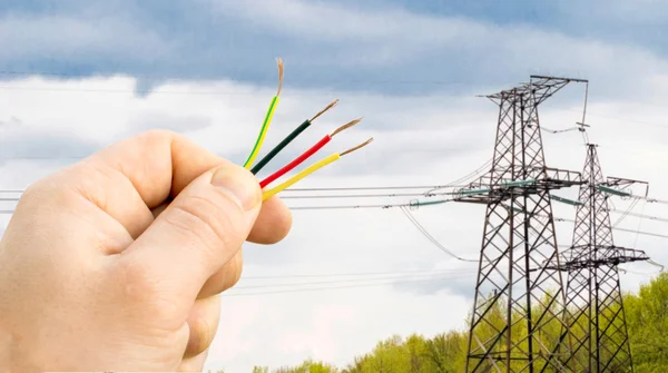 Wires in hand on the background Power lines — Stock Photo, Image