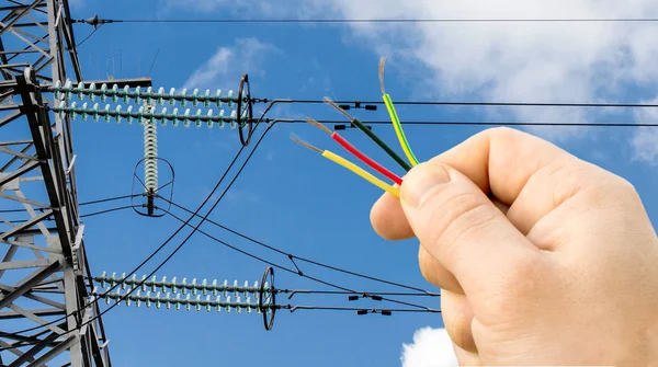 Wires in hand on the background Power lines — Stock Photo, Image