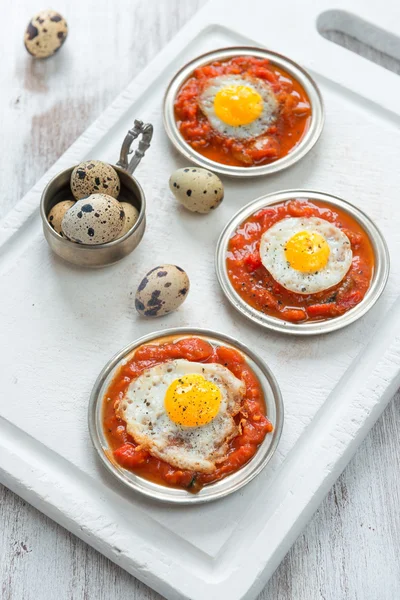 Omelette of quail eggs with tomato sauce — Stock Photo, Image