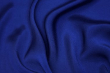 Mavi kumaş dokusu arka plan, dalgalı kumaş yumuşak mavi renk, lüks saten veya ipek kumaş dokusu.