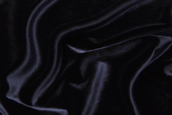 Velvet silk or cotton or wool fabric tissue. Dark gray or black color. Texture, background, pattern.