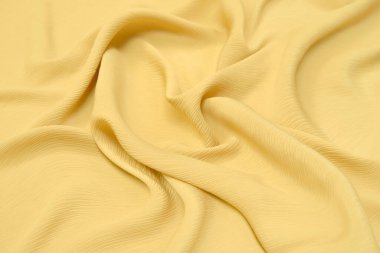 Doğal turuncu ya da sarı kumaş ya da kumaşın yakın çekim dokusu aynı renkte. Doğal pamuk, ipek, yün veya keten kumaş dokusu. Sarı tuval arkaplanı.