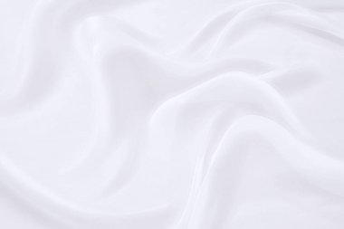 Beyaz kumaş arka planının soyut ve yumuşak odak dalgası, beyaz doku ve detay