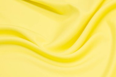 Güzel, pürüzsüz, zarif, sarı dalgalı, ya da altın rengi ipek, lüks kumaş kumaş, tasarım için soyut bir arkaplan. Boşluğu kopyala