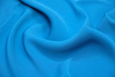 Pürüzsüz mavi ipek ya da saten lüks kumaş dokusu soyut arkaplan olarak kullanılabilir. Lüks arkaplan tasarımı