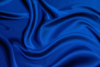 Tasarım için arkaplan (kalıp) olarak pürüzsüz mavi ipek (saten) kumaş