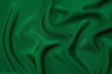 Doku, arka plan, desen. Yeşil ipek kumaş dokusu. Güzel zümrüt yeşil yumuşak ipek kumaş.