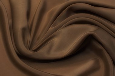 Sentetik kumaşın dokusu açık kahverengidir. Arkaplan, desen.