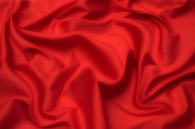 Doğal kırmızı ya da pembe kumaş ya da kumaşın yakın çekim dokusu aynı renkte. Doğal pamuk, ipek, yün veya keten kumaş dokusu. Kırmızı ve turuncu tuval arkaplan.