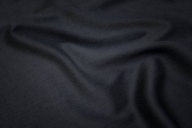 Doğal gri kumaşın yakın çekim dokusu ya da gri renkli kumaş. Doğal pamuk veya keten kumaş dokusu. Gri tuval arkaplanı