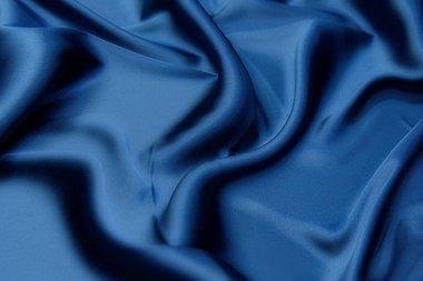 Mavi kumaş dokusu arka plan, dalgalı kumaş yumuşak mavi renk, lüks saten veya ipek kumaş dokusu.
