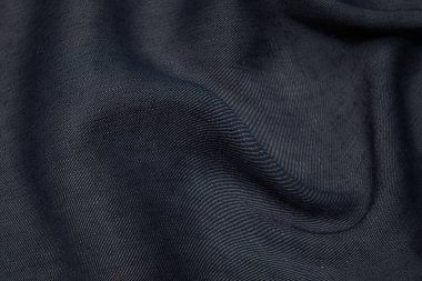 İpek ya da pamuk kumaş dokusu. Koyu gri ya da siyah renk. Doku, arkaplan, desen.