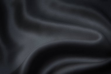 İpek ya da pamuk kumaş dokusu. Koyu gri ya da siyah renk. Doku, arkaplan, desen.