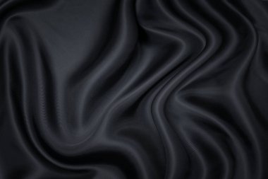 Siyah kumaş dokusu arka plan, dalgalı kumaş kaygan siyah renk, lüks saten ya da ipek ya da yün kumaş dokusu.