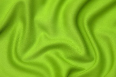 Doğal yeşil ya da salata rengi kumaş ya da kumaşın yakın çekim dokusu aynı renkte. Doğal pamuk, ipek, yün veya keten kumaş dokusu. Yeşil tuval arkaplanı.