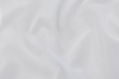 Doğal bej, fildişi, beyaz kumaş ya da kumaşın yakın çekim dokusu. Doğal pamuk, keten ya da ipek kumaş dokusu. Parlak renk tuval arkaplanı.