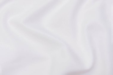 Doğal bej, fildişi, beyaz kumaş ya da kumaşın yakın çekim dokusu. Doğal pamuk, keten ya da ipek kumaş dokusu. Parlak renk tuval arkaplanı.