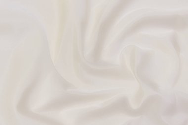 Doğal bej, fildişi, beyaz kumaş ya da kumaşın yakın çekim dokusu. Doğal pamuk, keten ya da ipek kumaş dokusu. Parlak renk tuval arkaplanı.