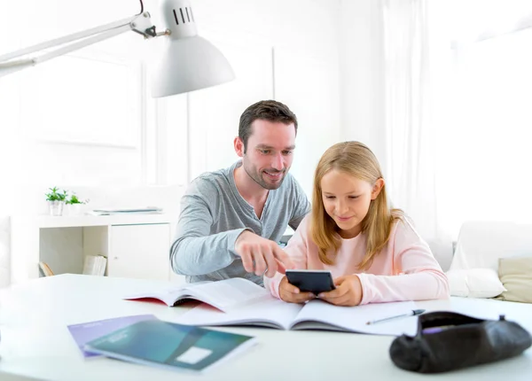 Father helping out her daughter for homework — Stock Photo, Image