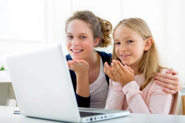 Attractive woman and little sister videocalling — Stock Photo, Image