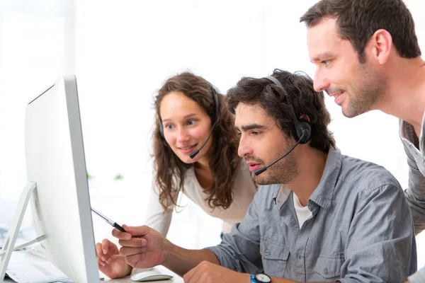 Group of people working around a computer — Stock Photo, Image