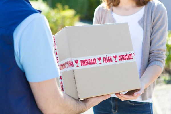 Details of parcel being handed over by a professional — Stock Photo, Image