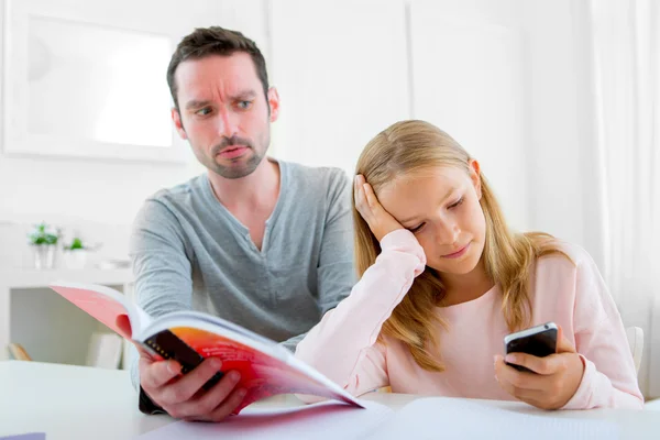 Young lazy girl prefers her mobile phone — Stock Photo, Image