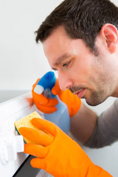 Young attractive man cleaning his flat — Stock Photo, Image