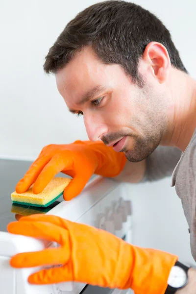 Young attractive man cleaning his flat — Stock Photo, Image