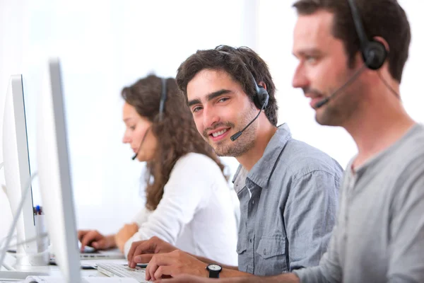 Young attractive man working in a call center — Stock Photo, Image