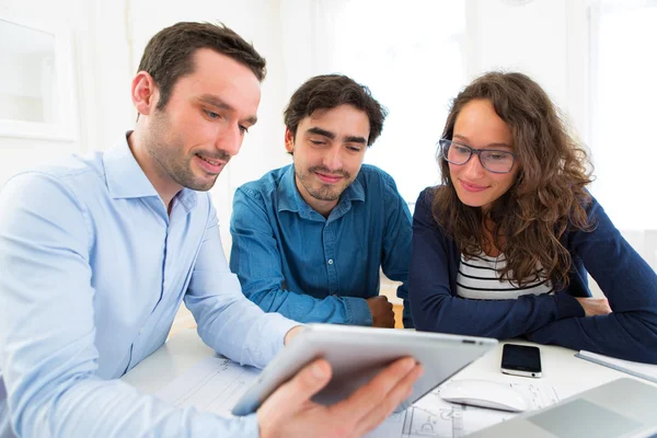 Young serious couple meeting a real estate agent — Stock Photo, Image