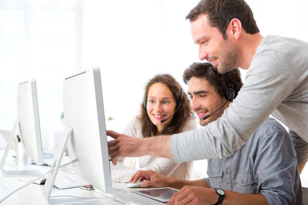 Group of people working around a computer — Stock Photo, Image