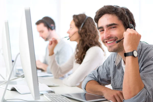 Young attractive man working in a call center — Stock Photo, Image