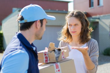 Young attractive woman angry against delivery man clipart