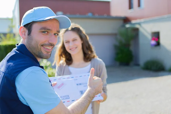 Delivery man handing over a registered letter — Stock Photo, Image