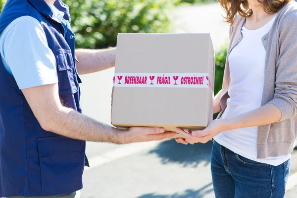 Details of parcel being handed over by a professional — Stock Photo, Image