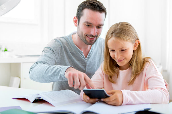 Father helping out her daughter for homework
