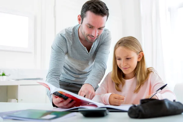 Father helping out her daughter for homework — Stock Photo, Image