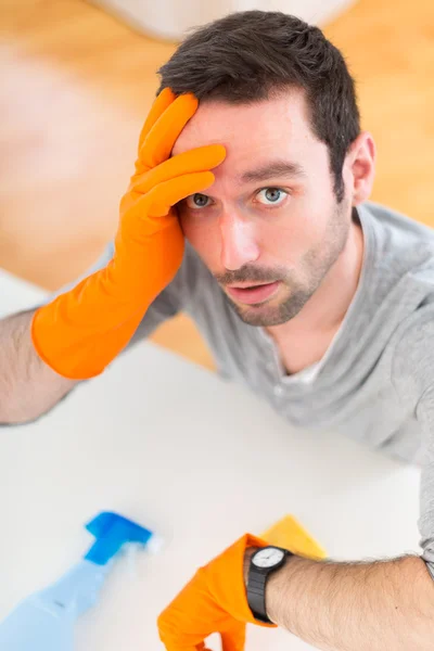 Young attractive man cleaning his flat — Stock Photo, Image