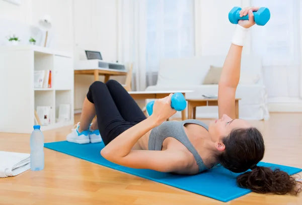 Young attractive girl doing exercise at home — Stock Photo, Image