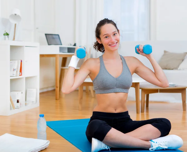 Young attractive girl doing exercise at home — Stock Photo, Image