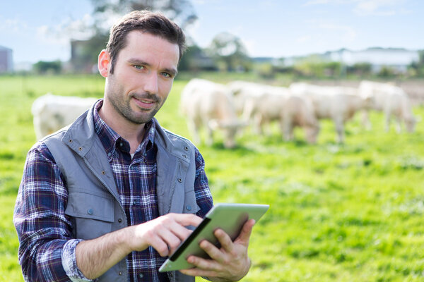 Young attractive farmer working in a field