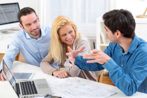 Young serious couple meeting a real estate agent — Stock Photo, Image