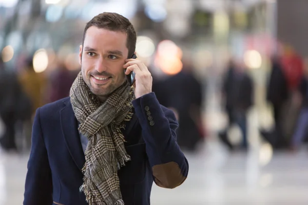 Young attractive man transiting a railway station — Stock Photo, Image